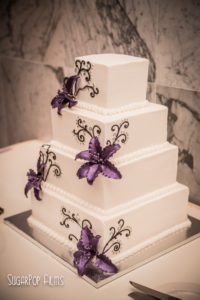 sleek white cake with purple flowers
