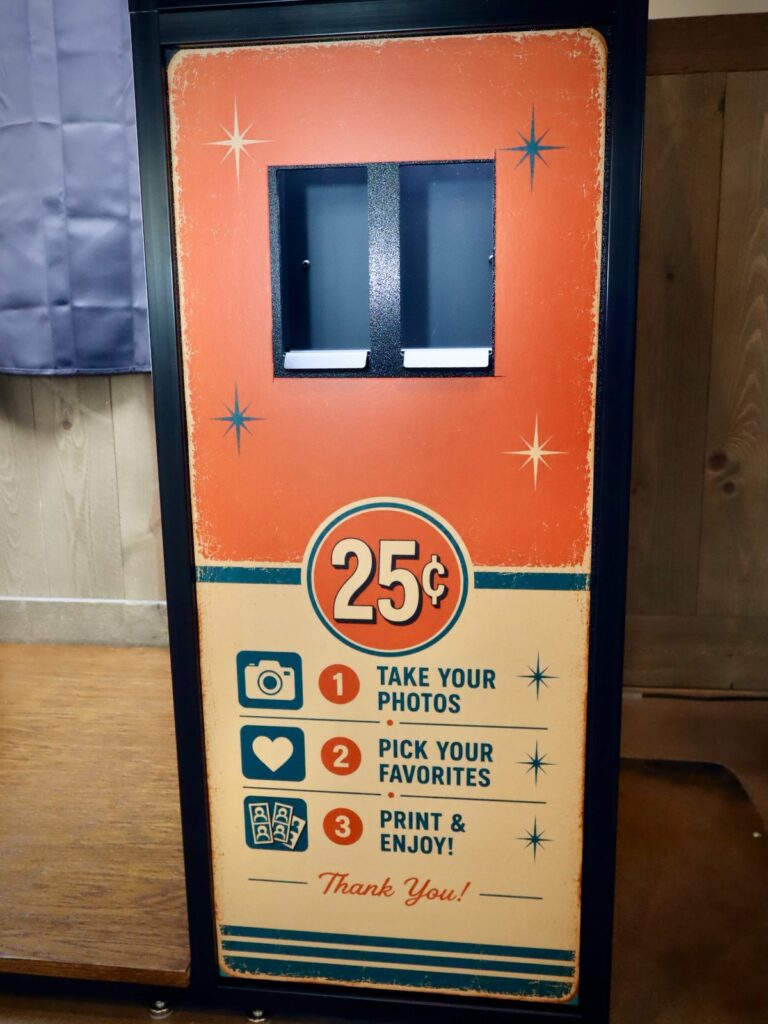Retro 25 cent print slot panel on the side of the enclosed photo booth