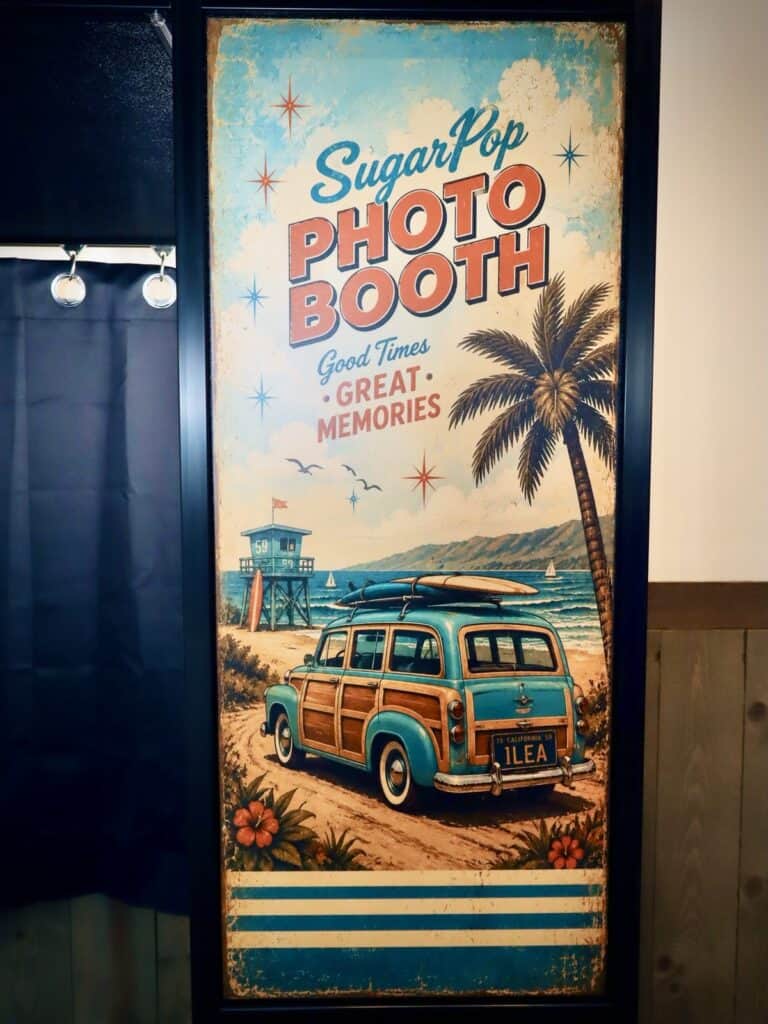 Booth wrap panel showing a classic woody wagon with a personalized ILEA license plate