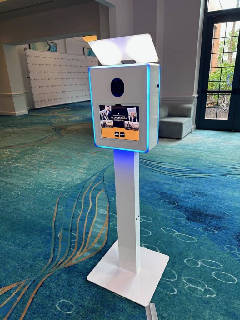 SugarPop AI photo booth kiosk on a white stand with blue edge lighting