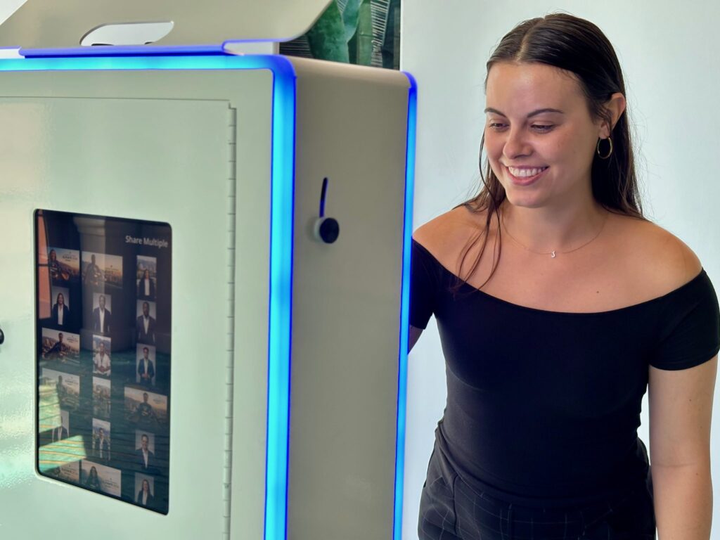 Conference attendee smiling at a SugarPop AI photo booth