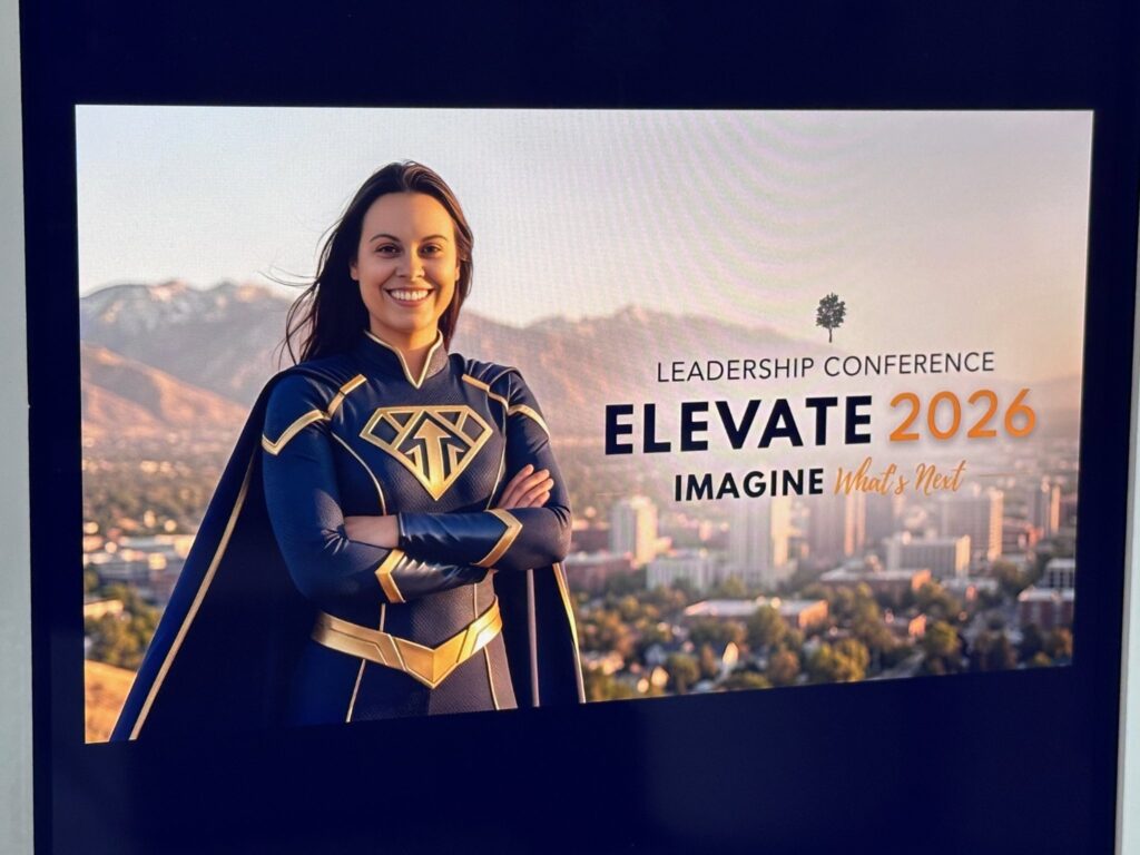 Superhero portrait displayed on a screen with Elevate 2026 Leadership Conference branding
